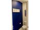 Nautical themed half-bath features dark blue walls, toilet, and framed artwork at 1349 Sunset Blvd, Avon, IN 46123