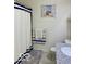 Well-lit bathroom featuring a white shower curtain, striped towels, and granite vanity at 1349 Sunset Blvd, Avon, IN 46123