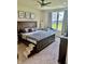 Bedroom features a large bed, ceiling fan, and a window providing natural light at 1349 Sunset Blvd, Avon, IN 46123