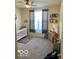 Cozy bedroom with neutral carpet, a crib, shelves with books, and gray curtains at 1349 Sunset Blvd, Avon, IN 46123