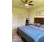 Cozy bedroom with a ceiling fan, framed art, and a comfortable blue-quilted bedspread at 1349 Sunset Blvd, Avon, IN 46123