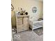 Bedroom with crib, gray carpet, decor and storage cabinet for baby at 1349 Sunset Blvd, Avon, IN 46123