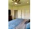 Inviting bedroom with a ceiling fan, soft lighting, and a comfortably made bed with a blue quilt at 1349 Sunset Blvd, Avon, IN 46123
