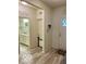Neutral entryway featuring a gray wood-look floor, and views of a bathroom and front door at 1349 Sunset Blvd, Avon, IN 46123