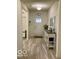 Bright entryway featuring a gray wood-look floor, front door, and console table at 1349 Sunset Blvd, Avon, IN 46123