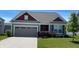 Charming single-story home with a two-car garage, manicured lawn, and lovely landscaping at 1349 Sunset Blvd, Avon, IN 46123