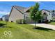 Well-maintained single-story home with green grass, landscaping, and an attached garage at 1349 Sunset Blvd, Avon, IN 46123