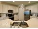 Bright kitchen with stainless steel appliances, white cabinetry and a stone countertop island at 1349 Sunset Blvd, Avon, IN 46123