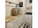 Well-organized laundry area with countertop, cabinets, washer, storage, and modern décor at 1349 Sunset Blvd, Avon, IN 46123