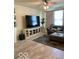 Cozy living room with a large TV, stylish console, and comfortable seating near the window at 1349 Sunset Blvd, Avon, IN 46123