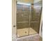 Modern bathroom shower features gray tiling and a glass sliding door enclosure at 1349 Sunset Blvd, Avon, IN 46123