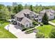 Expansive aerial view of a luxury home featuring an in-ground pool, three-car garage, and manicured grounds at 13909 Waterway Blvd, Fishers, IN 46040