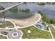 Aerial view featuring a sandy beach, playground, green park space, and lake access, offering a variety of recreational activities at 13909 Waterway Blvd, Fishers, IN 46040