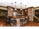 Entertain in style at this home bar featuring brick accents, a wood counter, and ample seating at 13909 Waterway Blvd, Fishers, IN 46040