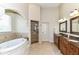 This bathroom features a glass-enclosed shower, soaking tub, and double sink vanity with granite counters at 13909 Waterway Blvd, Fishers, IN 46040