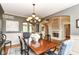 Elegant dining room featuring a wooden table, decorative chandelier, and an open view to the living area at 13909 Waterway Blvd, Fishers, IN 46040