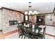 Inviting dining area features a stone fireplace, wood floors, and seamless flow to the living space at 13909 Waterway Blvd, Fishers, IN 46040