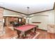 Entertain in this game room with a pool table, fireplace, and seamless flow to the living and dining areas at 13909 Waterway Blvd, Fishers, IN 46040