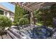 Relaxing hot tub nestled in a private backyard setting with a wooden pergola and lush greenery at 13909 Waterway Blvd, Fishers, IN 46040