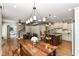 Open-concept kitchen and dining area with a large wooden table, chairs, and center island at 13909 Waterway Blvd, Fishers, IN 46040