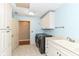 The laundry room includes a sink, a washer and dryer, and a cabinet for storage at 13909 Waterway Blvd, Fishers, IN 46040