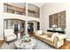 Elegant living room featuring a two-story ceiling, refined decor, and ample natural light at 13909 Waterway Blvd, Fishers, IN 46040