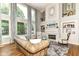 Bright and airy living room featuring large windows, fireplace, and stylish furnishings at 13909 Waterway Blvd, Fishers, IN 46040