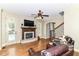 Inviting living room with a brick fireplace, hardwood floors, and a ceiling fan at 13909 Waterway Blvd, Fishers, IN 46040