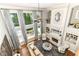 View of the living room with many windows, a fireplace, a ceiling fan, and modern décor at 13909 Waterway Blvd, Fishers, IN 46040