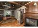 Private office with a wooden desk, built-in bookshelves, and a cozy fireplace at 13909 Waterway Blvd, Fishers, IN 46040