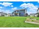 Spacious backyard features lush grass, and a glimpse of the home's rear exterior at 16598 Dominion Dr, Fortville, IN 46040