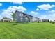 Expansive backyard showcases lush green grass, complemented by a charming blue two-story home at 16598 Dominion Dr, Fortville, IN 46040