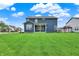 Large backyard features a well-maintained lawn and a view of the home's rear facade at 16598 Dominion Dr, Fortville, IN 46040