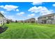Sprawling backyard boasts vibrant green grass and a view of neighboring homes at 16598 Dominion Dr, Fortville, IN 46040