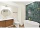Stunning bathroom features modern vanity, round mirror, stylish tub, and eye-catching green tile at 16598 Dominion Dr, Fortville, IN 46040