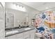 Bright bathroom features a double sink vanity, large mirror and fun, colorful shower curtain at 16598 Dominion Dr, Fortville, IN 46040
