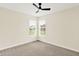Minimalist bedroom with a ceiling fan and a view of the neighborhood through the window at 16598 Dominion Dr, Fortville, IN 46040
