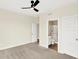 Bedroom with ceiling fan leading to a bathroom with glass enclosed shower at 16598 Dominion Dr, Fortville, IN 46040