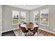Cozy breakfast nook features a wood table, chairs, and natural light from the windows at 16598 Dominion Dr, Fortville, IN 46040