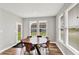 Dining room with hardwood floors, large windows for natural light, and access to the back door at 16598 Dominion Dr, Fortville, IN 46040