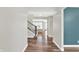 Inviting foyer with hardwood floors, stairs with black railings, and accent wall at 16598 Dominion Dr, Fortville, IN 46040