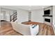 Cozy living room featuring a modern fireplace, hardwood floors, and a staircase at 16598 Dominion Dr, Fortville, IN 46040