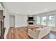 Spacious living room with a modern fireplace, large windows, and wood-look flooring at 16598 Dominion Dr, Fortville, IN 46040
