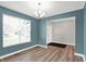 Bright living room features wood floors, a chandelier, and a large window with natural light at 16598 Dominion Dr, Fortville, IN 46040