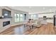 Bright open-concept living area featuring a fireplace, lots of natural light, and hardwood floors at 16598 Dominion Dr, Fortville, IN 46040