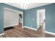 Open concept living area features hardwood flooring, modern chandelier, and neutral paint tones at 16598 Dominion Dr, Fortville, IN 46040