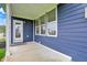 Covered patio with blue siding, white trim, and windows provides a relaxing outdoor space at 16598 Dominion Dr, Fortville, IN 46040