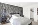 Bedroom featuring a patterned accent wall, plush pillows, and access to a closet at 1725 Hemlock Cir, Greenfield, IN 46140