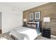 Inviting bedroom featuring a wood accent wall, modern lighting, and a comfortable bed for restful nights at 1725 Hemlock Cir, Greenfield, IN 46140