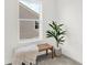 Bright bedroom nook with woven bench, textured throw blanket and lush potted plant at 1725 Hemlock Cir, Greenfield, IN 46140